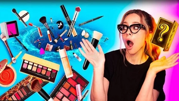 makeup products in a twirling blue hole with liza kondrevich questioning why that is